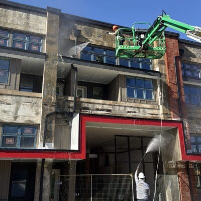 In Action Pressure Washing Building While Using a Lift in Chattanooga TN by QualityPRO Power Washing