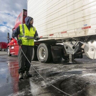 Employee Actively Pressure washing Trucks in Chattanooga TN by QualityPRO Power Washing