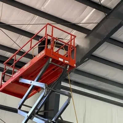 Using a Lift to Pressure Wash a storage space steel framed ceiling in Chattanooga TN by QualityPRO Power Washing