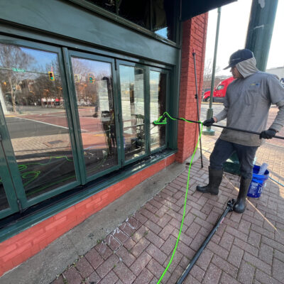 Pressure Washing and Cleaning Front Window At Hair of the dog Pub in Chattanooga TN by QualityPRO Power Washing