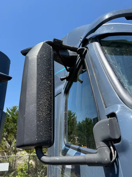 Pressure washing service completed on multiple semi trucks, focusing on the front end and upper cab areas to remove road film, grime, and buildup—leaving a cleaner, brighter finish and a more professional fleet appearance.