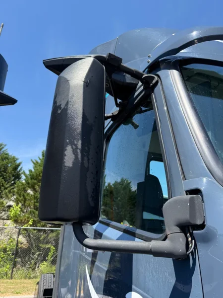 Pressure washing service completed on multiple semi trucks, focusing on the front end and upper cab areas to remove road film, grime, and buildup—leaving a cleaner, brighter finish and a more professional fleet appearance.