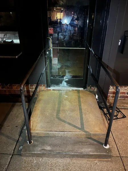 Commercial concrete pressure washing completed at a building entrance, removing heavy dirt and grime buildup to restore a cleaner, brighter, and safer walkway.