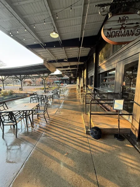 Commercial concrete pressure washing completed at a building entrance, removing heavy dirt and grime buildup to restore a cleaner, brighter, and safer walkway.