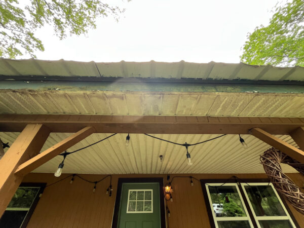 This project involved the soft washing of a one-story residence's exterior, its driveway and walkway pavers, and a stone fountain, alongside the cleaning of a commercial metal roof, to remove organic growth and restore the appearance of all surfaces in McDonald.