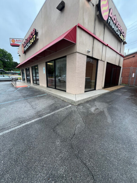The team performed a specialized low-pressure soft wash on a commercial awning system and a professional power wash on adjacent concrete surfaces in Chattanooga to remove organic growth and restore the property's curb appeal.