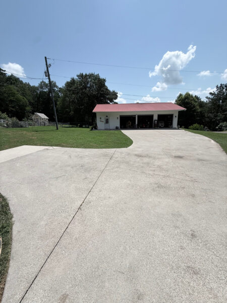 The contractor performed a comprehensive exterior cleaning in Chickamauga, utilizing soft washing for the home and workshop siding and professional surface cleaning for all concrete driveways, walkways, and patios.