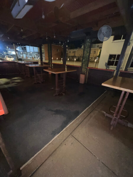 This project involved pressure washing a Chattanooga restaurant's front sidewalk, customer patio, and dumpster area using a municipal fire hydrant water source to remove dirt, stains, and grease for a cleaner appearance.