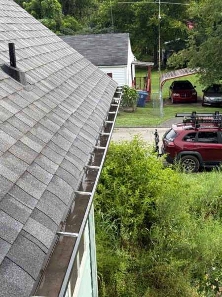 Using low-pressure soft washing methods, this project completed a full exterior refresh of a two-story home in Chattanooga, which included cleaning the house siding, front porch and back steps, washing the metal roof, and clearing and flushing the gutter system.