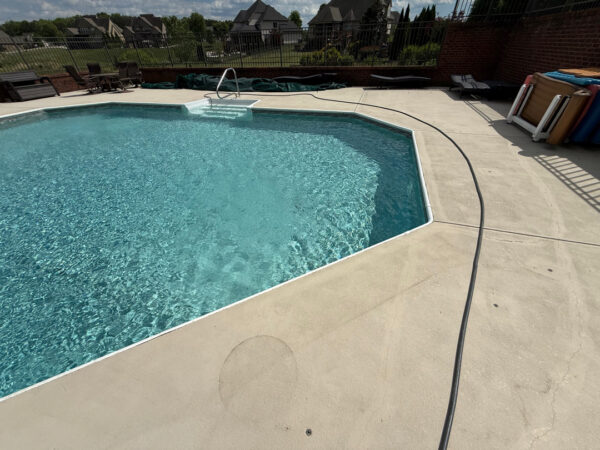 This comprehensive exterior restoration in Soddy-Daisy utilized professional soft-wash and pressure washing techniques to clean the home's siding, concrete surfaces, pool deck, three wood decks, patio furniture, retaining walls, and both interior and exterior windows.