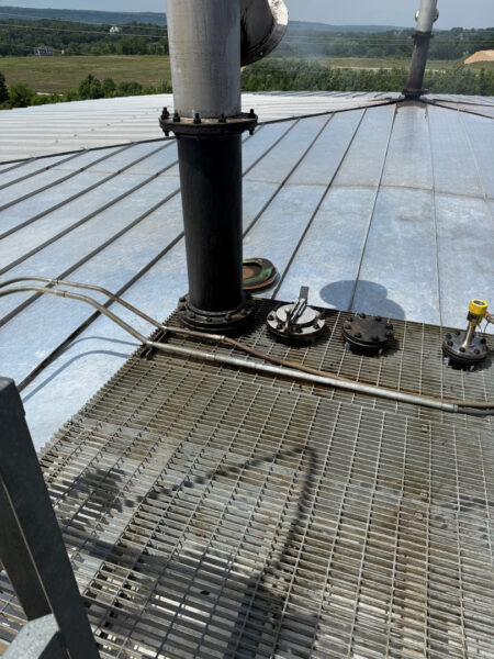 This project involved the complete cleaning and surface preparation of two industrial storage tanks' tops and upper walls using a 40-foot electric lift, pressure washing, and specialized detergents to remove mold, mildew, and dirt.