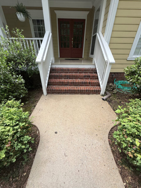 The team performed a targeted soft-wash of the front porches, vertical surfaces, and brick steps of a one-story residence in Chattanooga, complemented by a professional surface cleaning of the driveway, sidewalk, and walkways to enhance curb appeal.