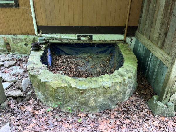 This project involved the soft washing of a one-story residence's exterior, its driveway and walkway pavers, and a stone fountain, alongside the cleaning of a commercial metal roof, to remove organic growth and restore the appearance of all surfaces in McDonald.