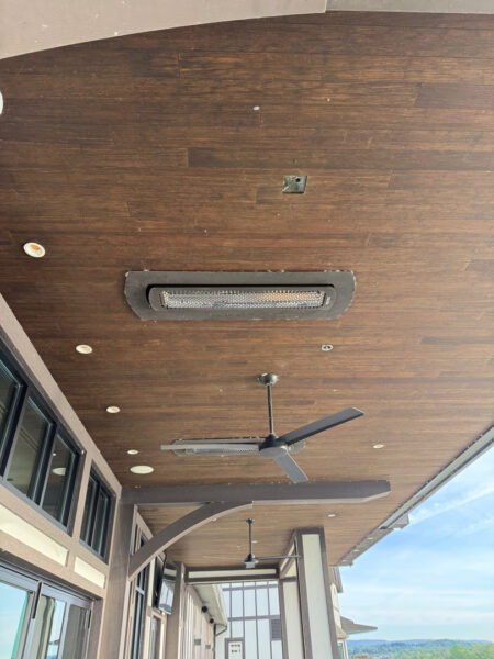 This Chattanooga project utilized surface and soft washing techniques to deep clean the rear walkway, under-deck concrete, and 1896 bar patio while specifically removing red clay stains from the chimney and retaining walls.