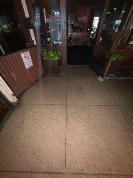 This project involved pressure washing a Chattanooga restaurant's front sidewalk, customer patio, and dumpster area using a municipal fire hydrant water source to remove dirt, stains, and grease for a cleaner appearance.