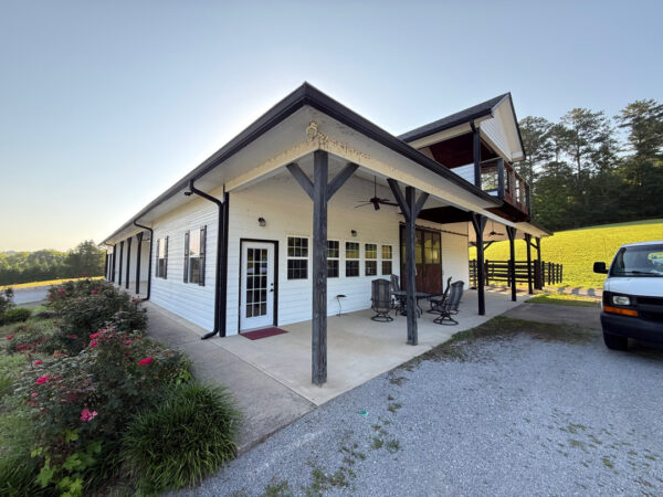 This project involved a complete exterior soft wash of a one-story barndominium in Collegedale, including its walls, dormers, covered porches, and trim, utilizing low-pressure cleaning and detergents to remove organic growth and dirt with a one-year warranty.