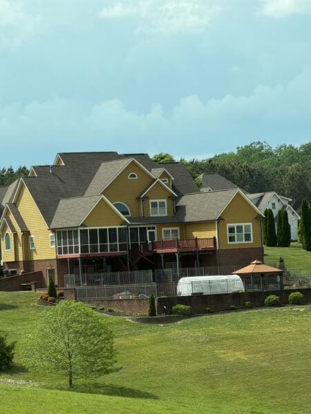 This comprehensive exterior restoration in Soddy-Daisy utilized professional soft-wash and pressure washing techniques to clean the home's siding, concrete surfaces, pool deck, three wood decks, patio furniture, retaining walls, and both interior and exterior windows.