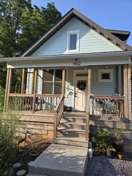 Using low-pressure soft washing methods, this project completed a full exterior refresh of a two-story home in Chattanooga, which included cleaning the house siding, front porch and back steps, washing the metal roof, and clearing and flushing the gutter system.