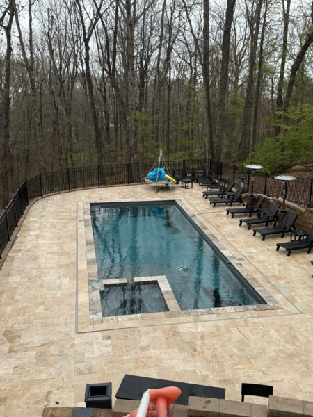 The work performed consists of soft washing and rinsing the primary structure's exterior surfaces, three rear decks, a treehouse with its decks and bridges, and surface cleaning the concrete flatwork, all backed by a one-year warranty against mold and mildew regrowth.