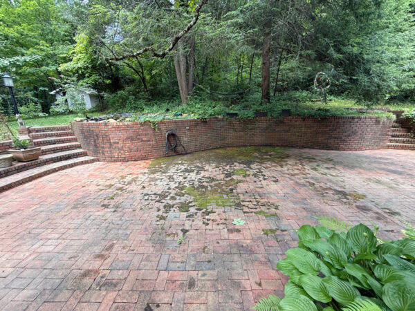 This project involved a comprehensive exterior cleaning of a Chattanooga residence's retaining wall, patio pavers, driveway, and front porch using specialized detergents and pressure washing to remove organic growth and surface debris.