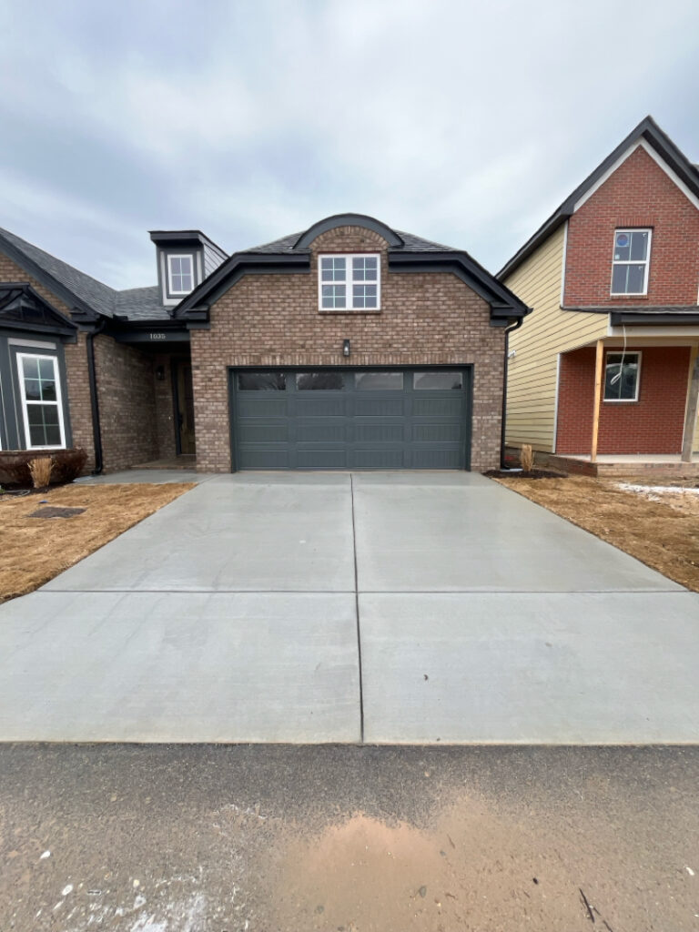 The project involved a comprehensive exterior rinse of a newly constructed home in Chattanooga, including the siding, garage, driveway, and walkways, to remove construction dust and debris for a move-in-ready finish.