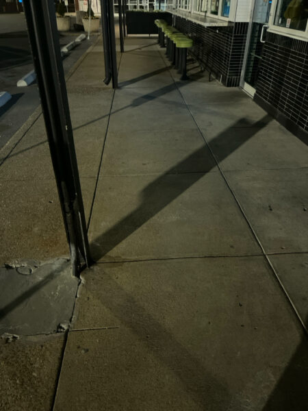 The front patio concrete at Milk and Honey was professionally restored through a multi-step process involving site protection, specialized detergent application, targeted pressure washing, and a final rinse to remove organic growth and grease.