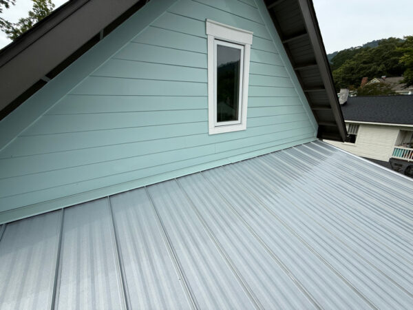 Using low-pressure soft washing methods, this project completed a full exterior refresh of a two-story home in Chattanooga, which included cleaning the house siding, front porch and back steps, washing the metal roof, and clearing and flushing the gutter system.