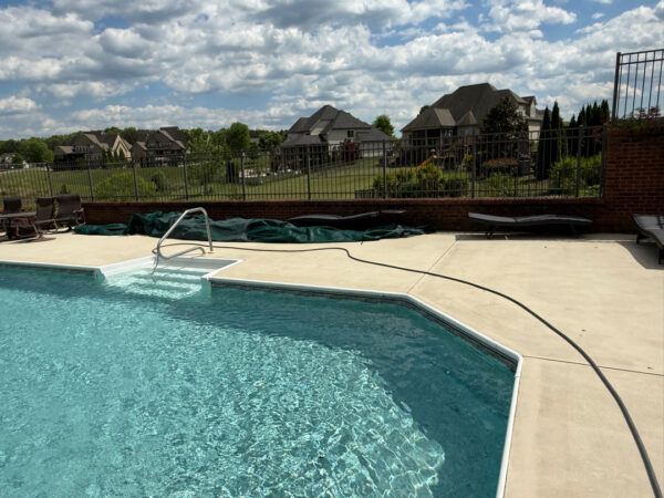 This comprehensive exterior restoration in Soddy-Daisy utilized professional soft-wash and pressure washing techniques to clean the home's siding, concrete surfaces, pool deck, three wood decks, patio furniture, retaining walls, and both interior and exterior windows.
