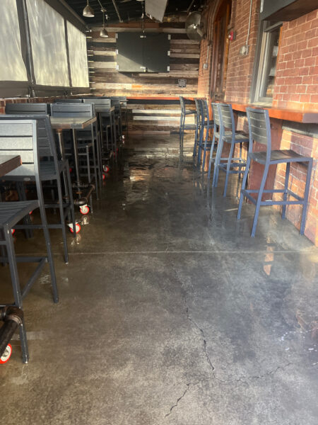 The project at Urban Stack in Chattanooga involved inspecting and thoroughly pressure washing the restaurant's exterior sidewalks, dining patios, and side entrance to remove dirt, stains, and grease, thereby restoring a clean appearance and improving pedestrian safety.