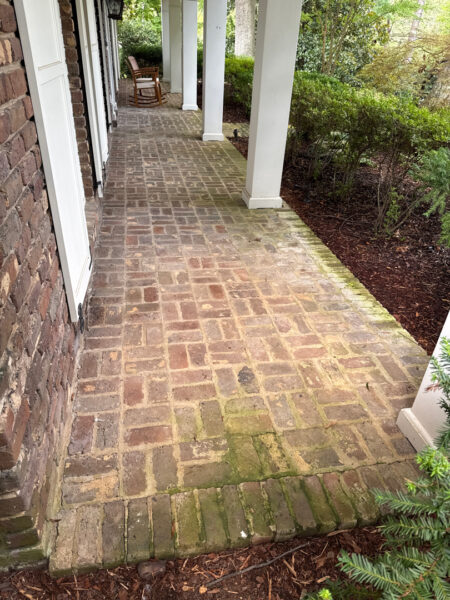 This project involved a comprehensive soft wash and detailed exterior cleaning of a Chattanooga residence, encompassing the house, porches, concrete surfaces, gutters, and outbuildings to remove organic buildup and restore a uniform appearance.