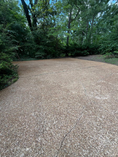 This project involved a comprehensive exterior cleaning of a Chattanooga residence's retaining wall, patio pavers, driveway, and front porch using specialized detergents and pressure washing to remove organic growth and surface debris.