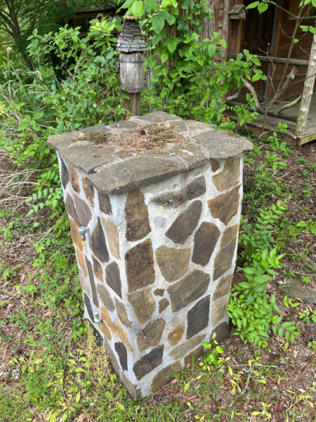 This project involved the soft washing of a one-story residence's exterior, its driveway and walkway pavers, and a stone fountain, alongside the cleaning of a commercial metal roof, to remove organic growth and restore the appearance of all surfaces in McDonald.