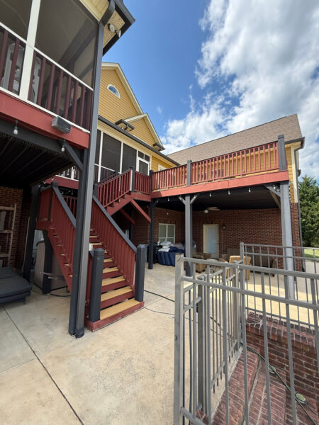 This comprehensive exterior restoration in Soddy-Daisy utilized professional soft-wash and pressure washing techniques to clean the home's siding, concrete surfaces, pool deck, three wood decks, patio furniture, retaining walls, and both interior and exterior windows.