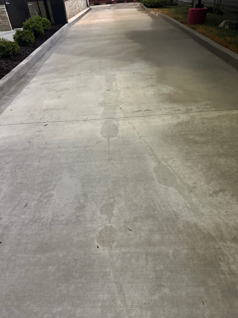 This commercial exterior restoration project in Ooltewah revitalized the property's curb appeal by thoroughly cleaning the building's facade, awnings, drive-thru lane, dumpster pad, and parking areas to remove heavy grime, stains, and organic buildup.
