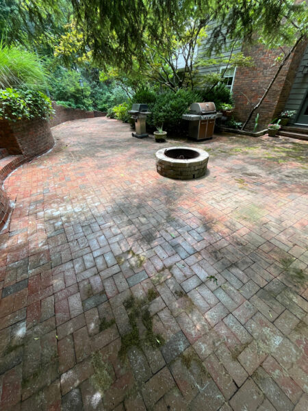 This project involved a comprehensive exterior cleaning of a Chattanooga residence's retaining wall, patio pavers, driveway, and front porch using specialized detergents and pressure washing to remove organic growth and surface debris.