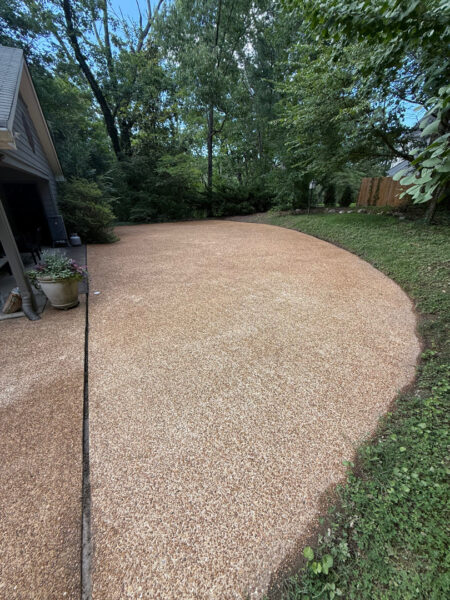 This project involved a comprehensive exterior cleaning of a Chattanooga residence's retaining wall, patio pavers, driveway, and front porch using specialized detergents and pressure washing to remove organic growth and surface debris.