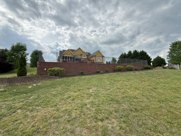 This comprehensive exterior restoration in Soddy-Daisy utilized professional soft-wash and pressure washing techniques to clean the home's siding, concrete surfaces, pool deck, three wood decks, patio furniture, retaining walls, and both interior and exterior windows.