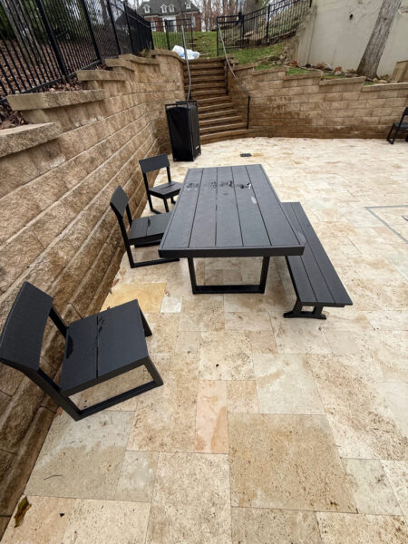 The work performed consists of soft washing and rinsing the primary structure's exterior surfaces, three rear decks, a treehouse with its decks and bridges, and surface cleaning the concrete flatwork, all backed by a one-year warranty against mold and mildew regrowth.