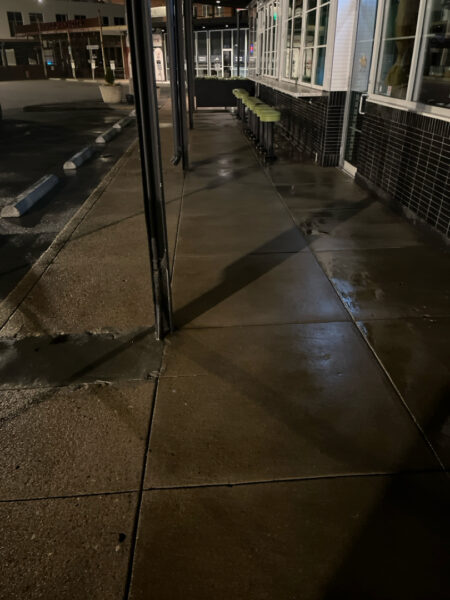 The front patio concrete at Milk and Honey was professionally restored through a multi-step process involving site protection, specialized detergent application, targeted pressure washing, and a final rinse to remove organic growth and grease.