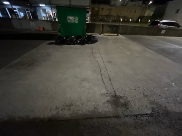 This project involved pressure washing a Chattanooga restaurant's front sidewalk, customer patio, and dumpster area using a municipal fire hydrant water source to remove dirt, stains, and grease for a cleaner appearance.