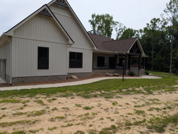A complete exterior soft wash was performed on a one-story residence in Rising Fawn, thoroughly cleaning the soffits, fascia, gutters, downspouts, and siding using a low-pressure system and gentle agitation to safely remove organic growth and dirt.