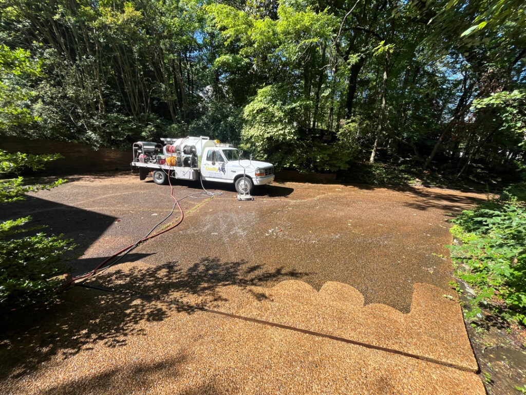 This project involved a comprehensive exterior cleaning of a Chattanooga residence's retaining wall, patio pavers, driveway, and front porch using specialized detergents and pressure washing to remove organic growth and surface debris.