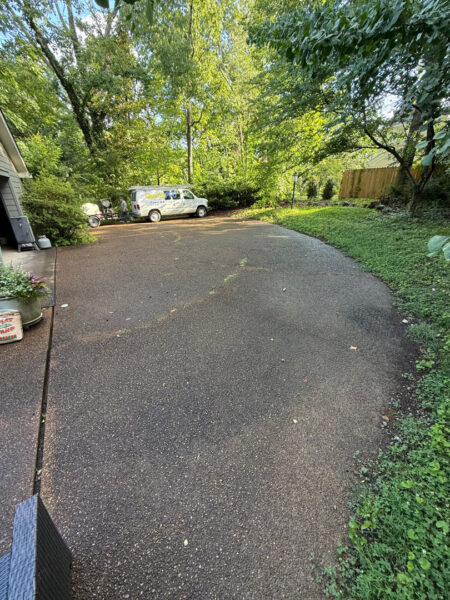 This project involved a comprehensive exterior cleaning of a Chattanooga residence's retaining wall, patio pavers, driveway, and front porch using specialized detergents and pressure washing to remove organic growth and surface debris.
