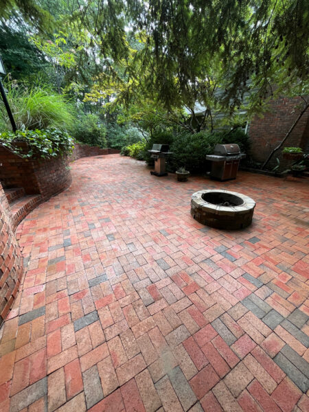This project involved a comprehensive exterior cleaning of a Chattanooga residence's retaining wall, patio pavers, driveway, and front porch using specialized detergents and pressure washing to remove organic growth and surface debris.