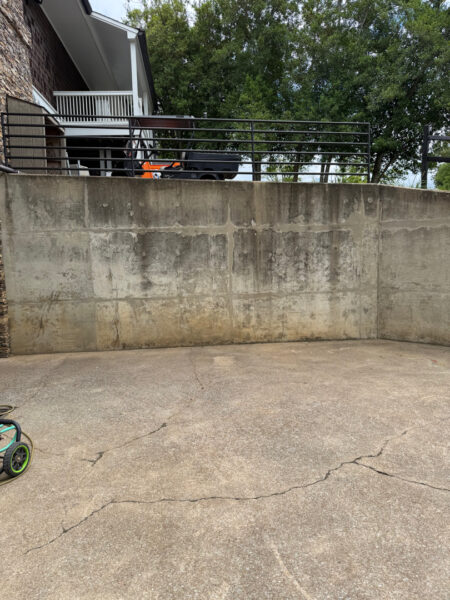 This commercial project in Chattanooga involved a comprehensive soft wash and surface cleaning of a masonry retaining wall, building exteriors, and pedestrian access areas to remove organic growth while protecting on-site fire safety equipment.