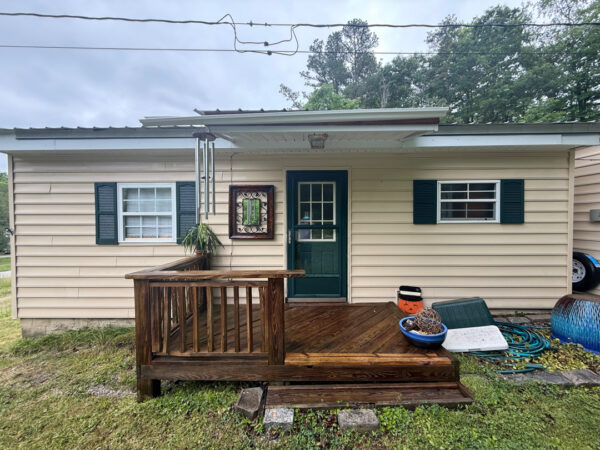 This project involved a comprehensive low-pressure soft wash of a single-story home's exterior surfaces, including siding, trim, and gutters, to remove organic growth and restore a uniform appearance.