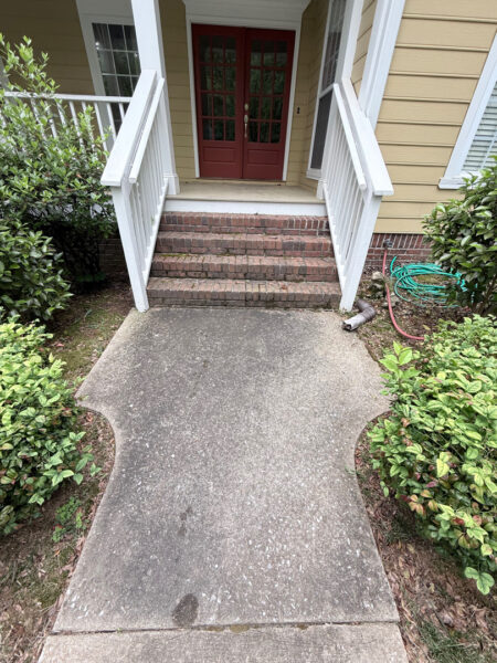 The team performed a targeted soft-wash of the front porches, vertical surfaces, and brick steps of a one-story residence in Chattanooga, complemented by a professional surface cleaning of the driveway, sidewalk, and walkways to enhance curb appeal.
