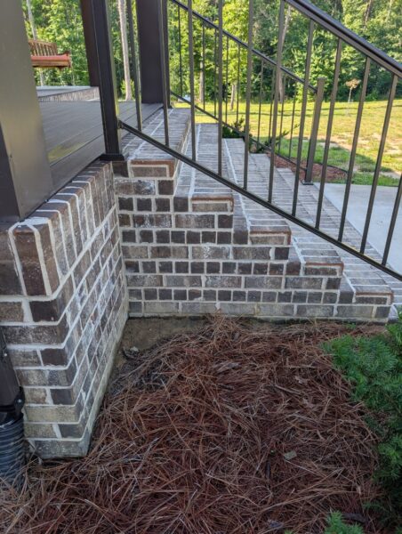 A complete exterior soft wash was performed on a one-story residence in Rising Fawn, thoroughly cleaning the soffits, fascia, gutters, downspouts, and siding using a low-pressure system and gentle agitation to safely remove organic growth and dirt.
