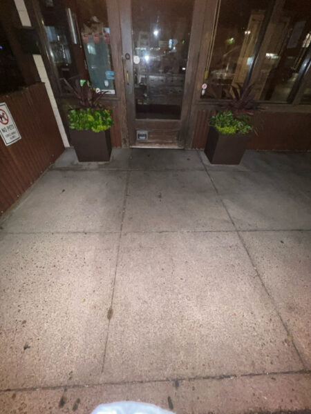This project involved pressure washing a Chattanooga restaurant's front sidewalk, customer patio, and dumpster area using a municipal fire hydrant water source to remove dirt, stains, and grease for a cleaner appearance.