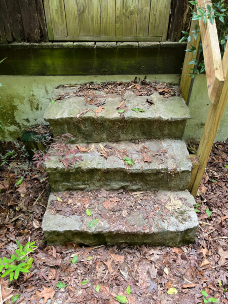 This project involved the soft washing of a one-story residence's exterior, its driveway and walkway pavers, and a stone fountain, alongside the cleaning of a commercial metal roof, to remove organic growth and restore the appearance of all surfaces in McDonald.
